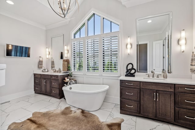 bathroom with a bath, crown molding, vanity, and a notable chandelier