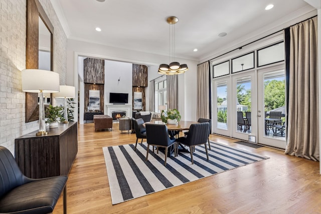 dining room featuring ornamental molding and light hardwood / wood-style floors