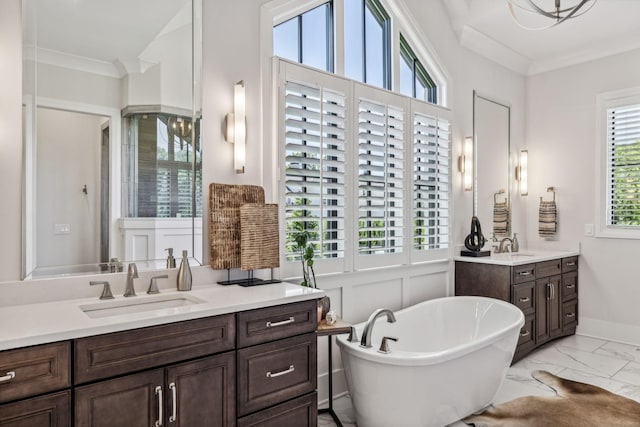 bathroom featuring vanity, ornamental molding, and a bath