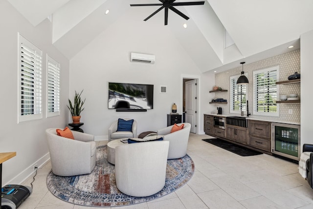 living room featuring wine cooler, ceiling fan, a wall mounted AC, sink, and high vaulted ceiling