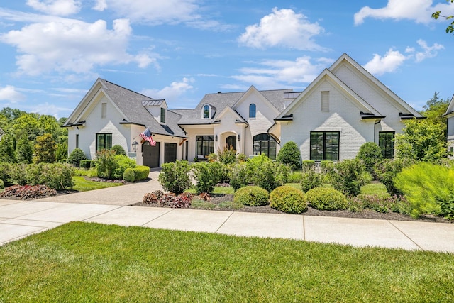 french provincial home featuring a front yard