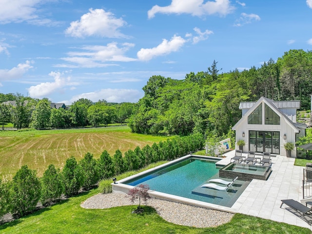 view of pool featuring a patio area, an in ground hot tub, and a yard