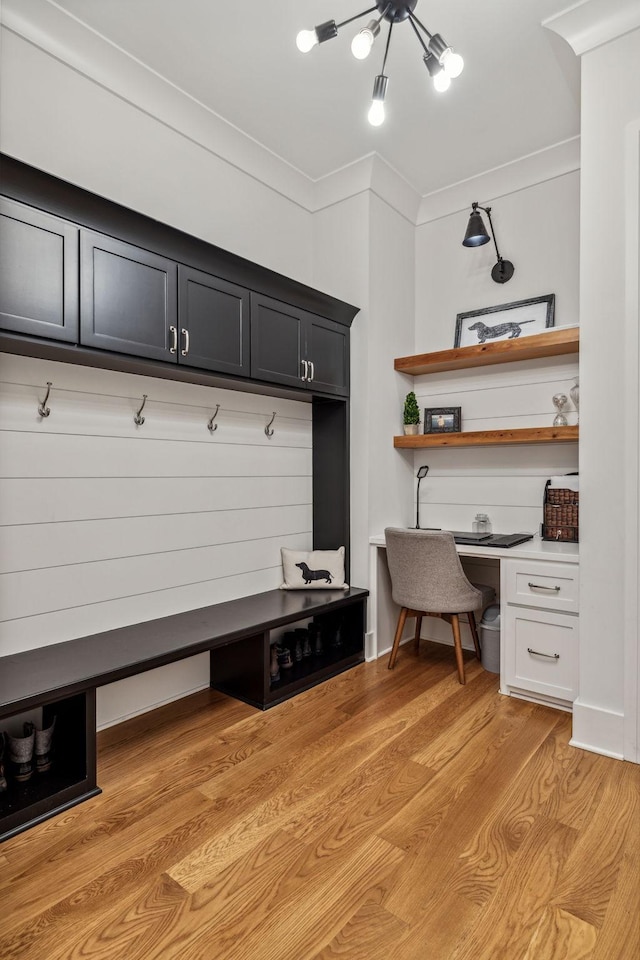 mudroom featuring light wood-type flooring and ornamental molding