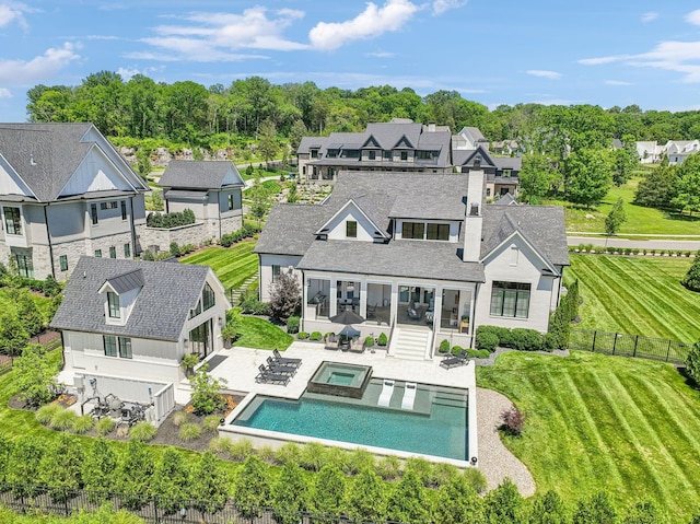 rear view of property featuring a sunroom and a patio