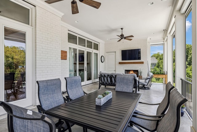 view of patio / terrace with an outdoor brick fireplace and ceiling fan