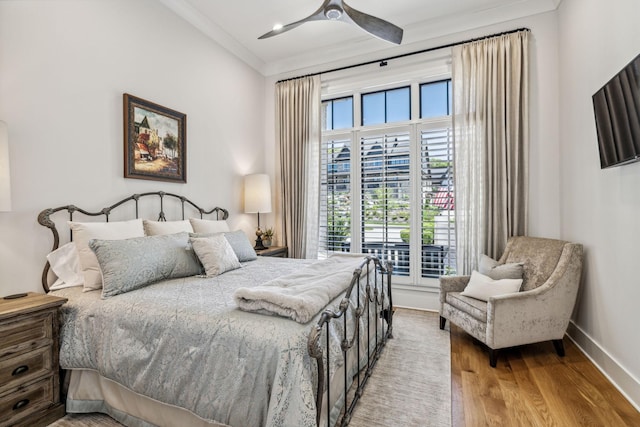 bedroom with ceiling fan, crown molding, and hardwood / wood-style floors