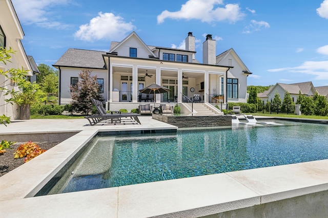 rear view of house with ceiling fan and a patio area