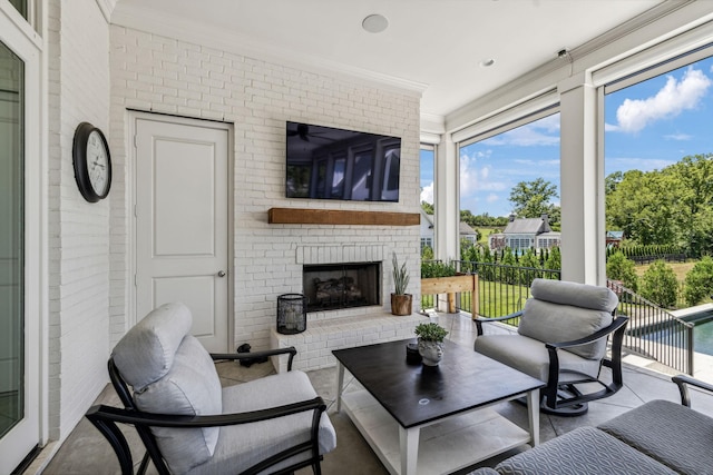 sunroom featuring an outdoor brick fireplace