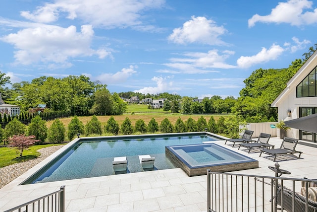 view of pool featuring a patio area and an in ground hot tub