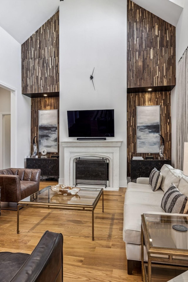 living room featuring high vaulted ceiling and wood-type flooring