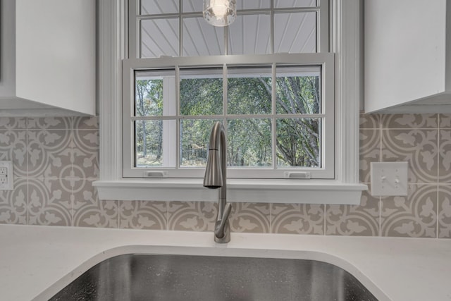 room details featuring decorative backsplash and sink