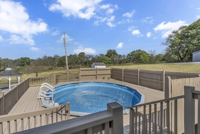 view of pool featuring a wooden deck and a gazebo