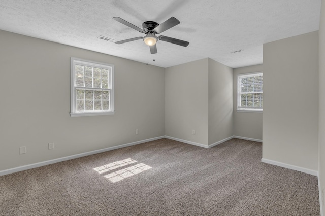 unfurnished room featuring a textured ceiling, ceiling fan, and carpet