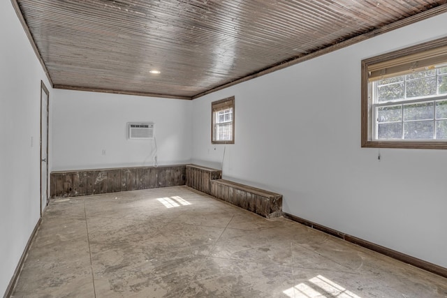 spare room featuring a healthy amount of sunlight, wood ceiling, crown molding, and a wall mounted air conditioner