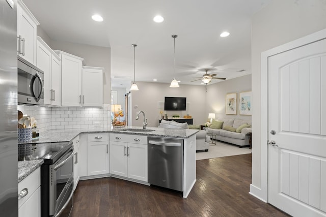 kitchen with ceiling fan, white cabinets, appliances with stainless steel finishes, and dark wood-type flooring