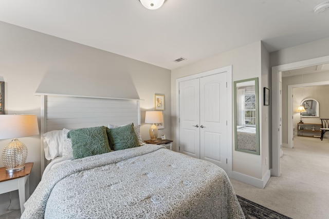 bedroom featuring light colored carpet and a closet