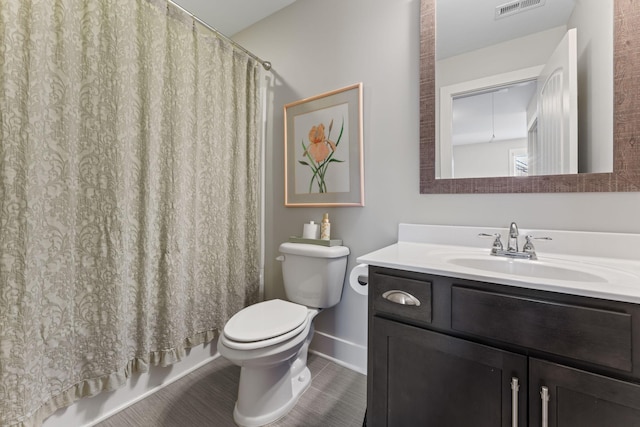 bathroom featuring toilet, vanity, and a shower with shower curtain