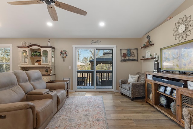 living room featuring ceiling fan and light hardwood / wood-style flooring