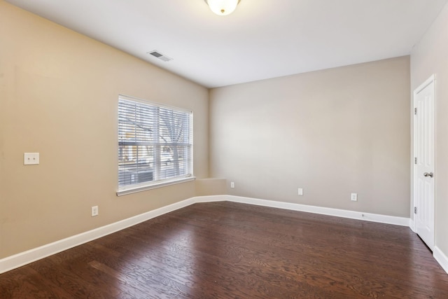 unfurnished room with dark hardwood / wood-style flooring