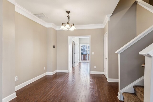 interior space featuring a chandelier, crown molding, and dark hardwood / wood-style floors