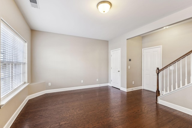 unfurnished room featuring dark hardwood / wood-style flooring