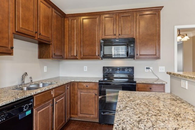 kitchen with dark wood-type flooring, sink, black appliances, and light stone countertops