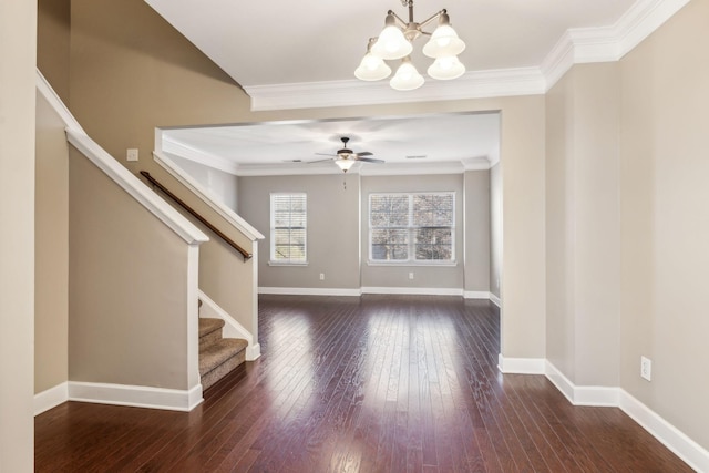 interior space featuring ceiling fan with notable chandelier, dark hardwood / wood-style floors, and ornamental molding