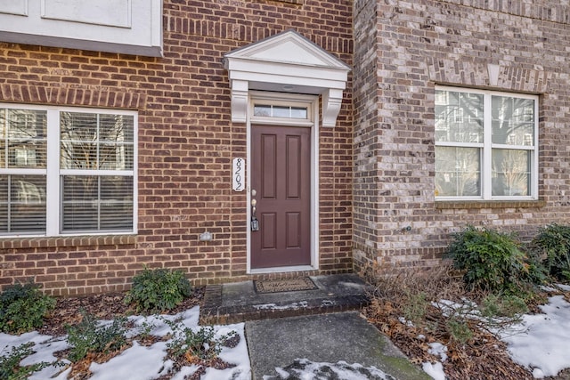 view of snow covered property entrance