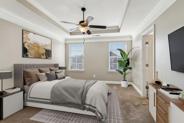 bedroom with ceiling fan, carpet, a tray ceiling, and ornamental molding