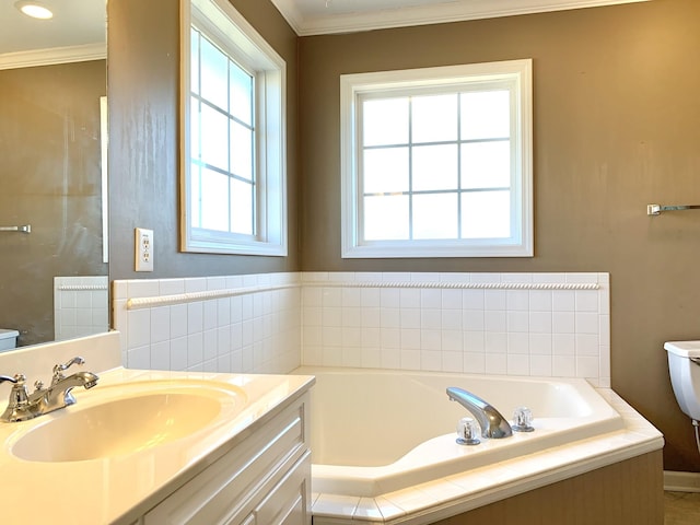 bathroom featuring toilet, ornamental molding, a tub to relax in, and vanity