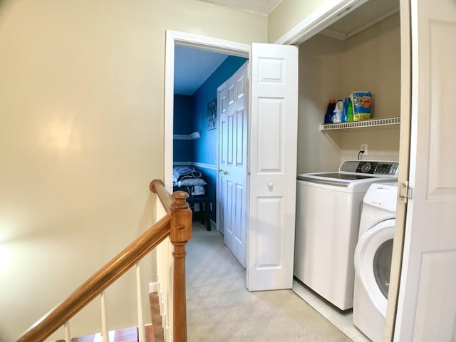 washroom with light colored carpet and washing machine and dryer