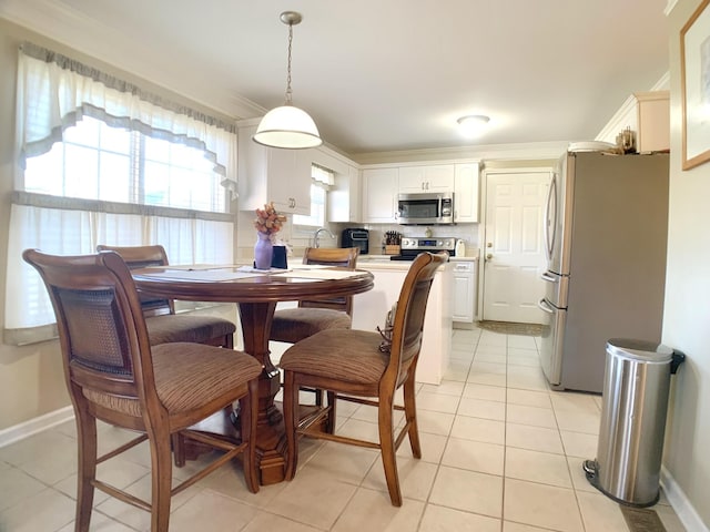 tiled dining area featuring crown molding