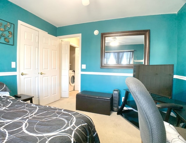 carpeted bedroom with washer / dryer and a closet