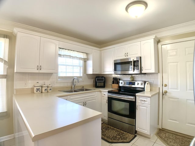 kitchen featuring white cabinets, appliances with stainless steel finishes, sink, kitchen peninsula, and light tile patterned floors