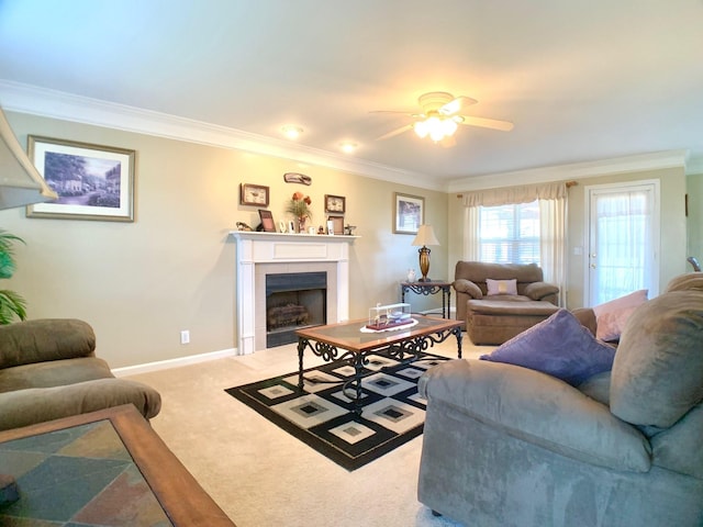 carpeted living room with ceiling fan and crown molding