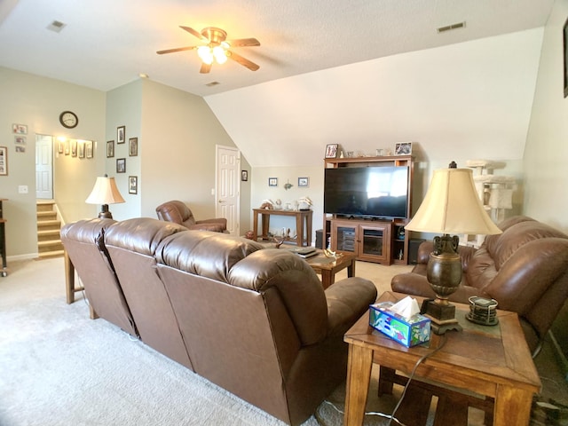 carpeted living room with vaulted ceiling and ceiling fan