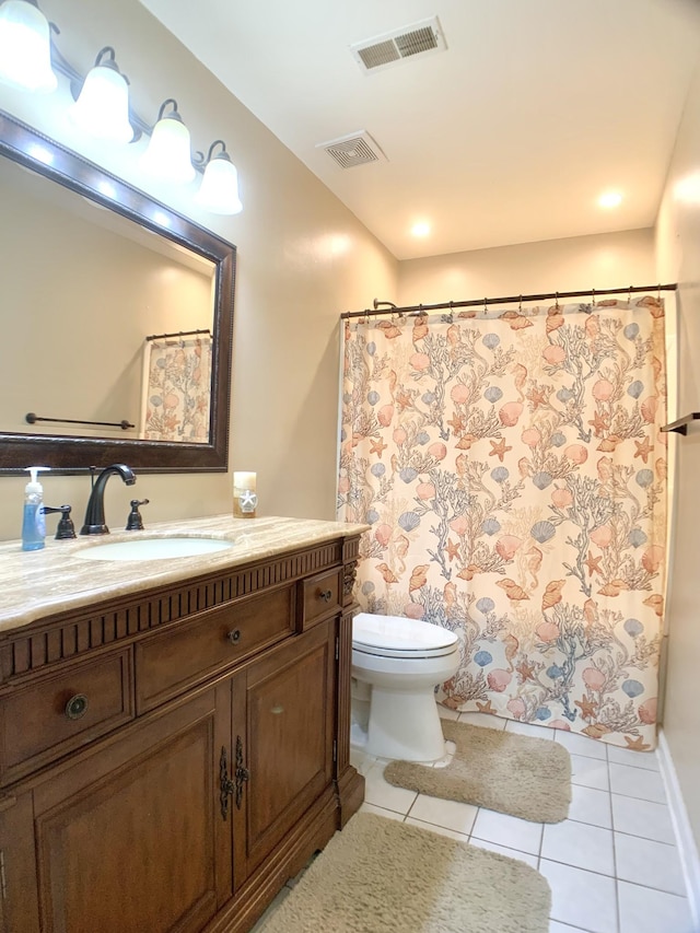 bathroom with tile patterned floors, vanity, and toilet