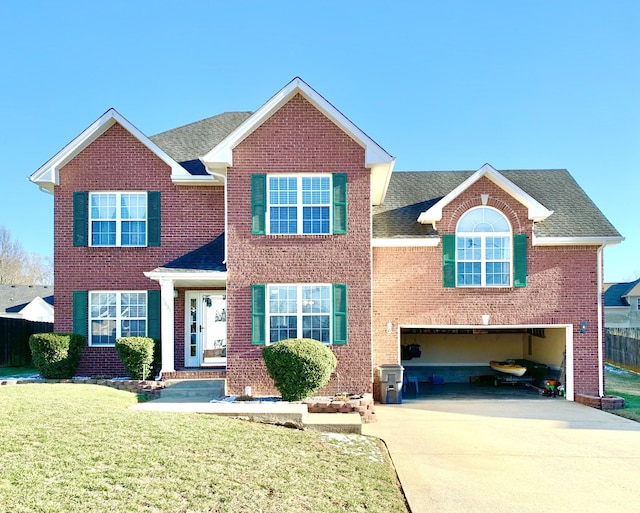 view of front of home featuring a front lawn and a garage