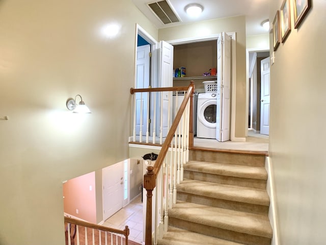 stairway featuring washer and clothes dryer