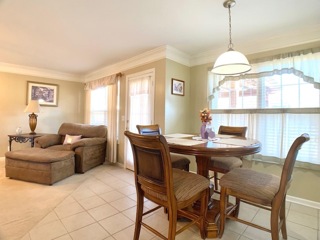 tiled dining room featuring crown molding