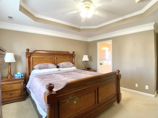 carpeted bedroom featuring ensuite bath, ceiling fan, crown molding, and a raised ceiling