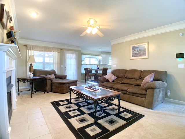 carpeted living room with ceiling fan and ornamental molding