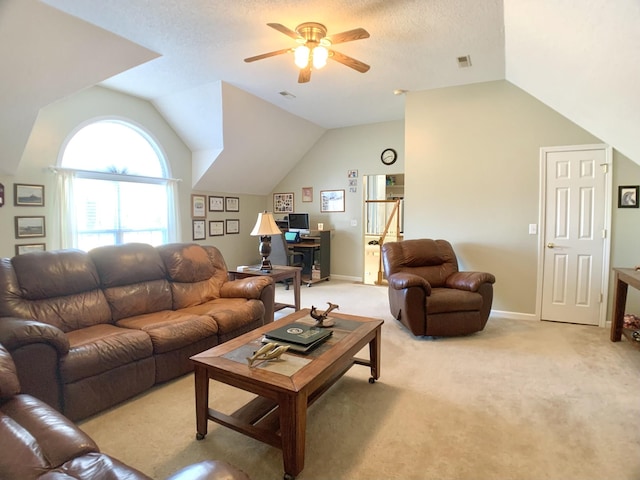 carpeted living room with ceiling fan, vaulted ceiling, and a textured ceiling