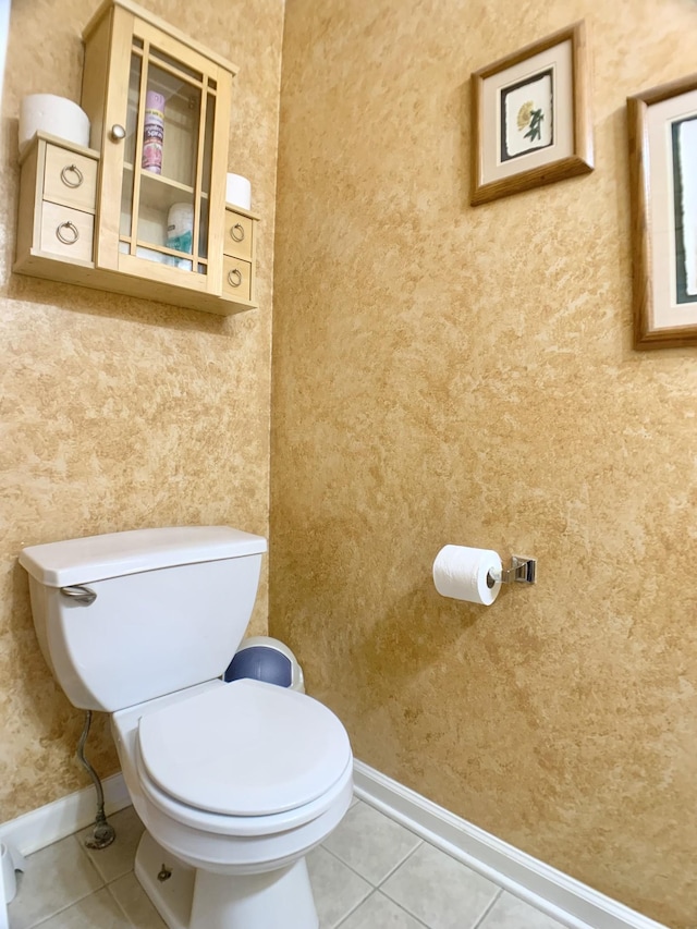 bathroom with toilet and tile patterned floors