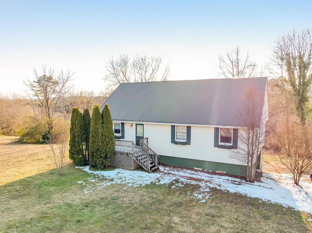 view of front of home featuring a front lawn and a wooden deck