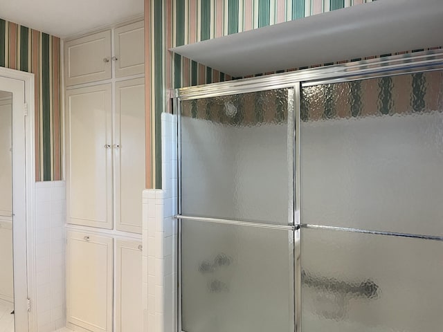 bathroom with a shower with shower door