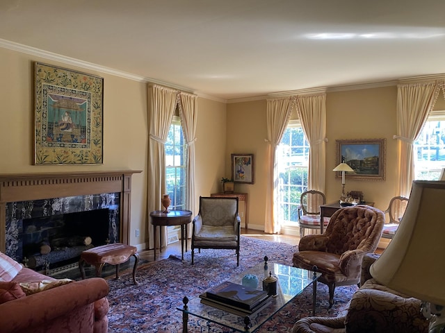 sitting room featuring wood-type flooring, a high end fireplace, and crown molding