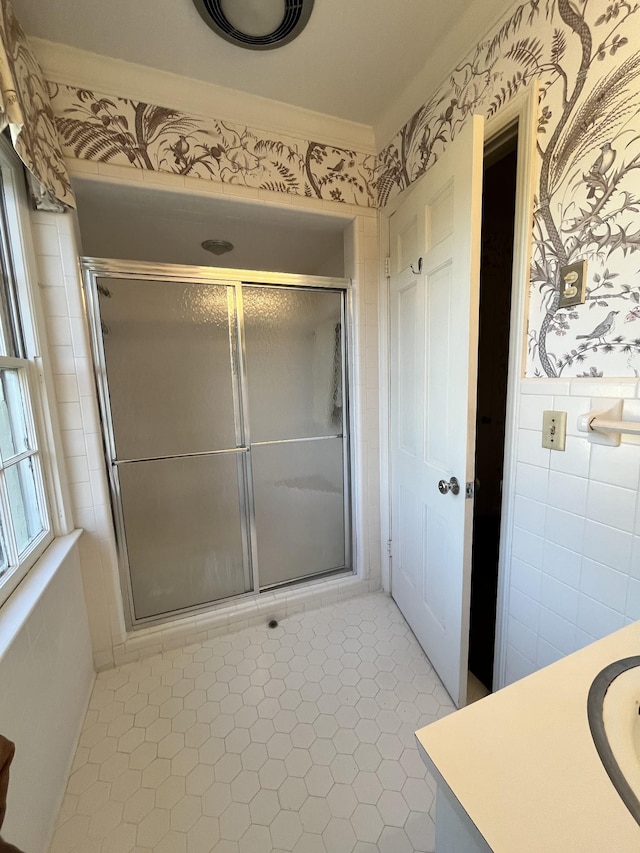 bathroom featuring walk in shower, ornamental molding, vanity, and tile patterned flooring