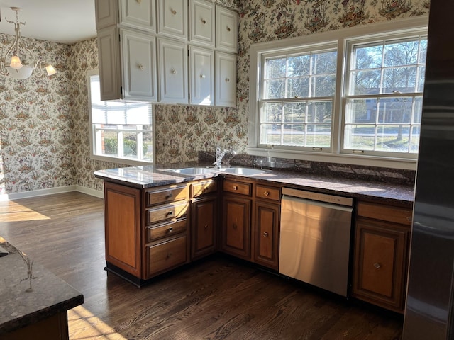 kitchen featuring dishwasher, dark hardwood / wood-style flooring, sink, kitchen peninsula, and refrigerator