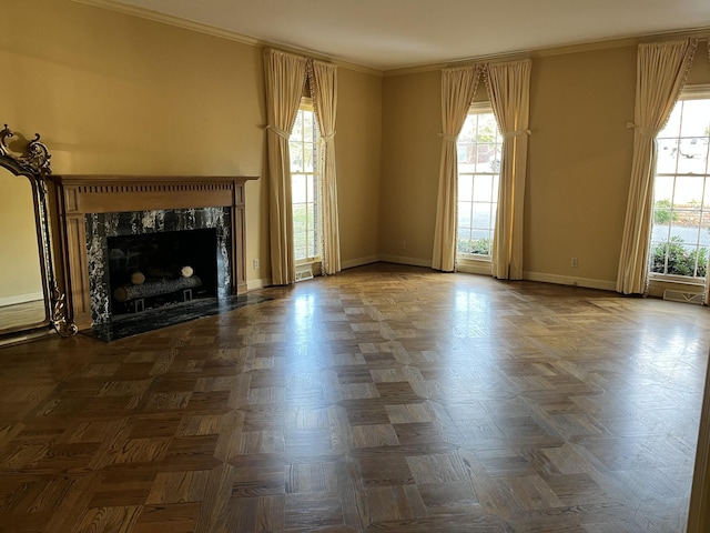 unfurnished living room with a healthy amount of sunlight, a fireplace, and parquet floors